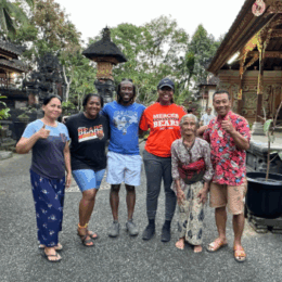 counseling students stand outside with locals in Bali