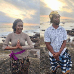 a female and male counseling students stand and smile in front of the sunset