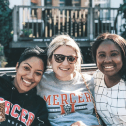 group of three female counseling students smiling at the camera