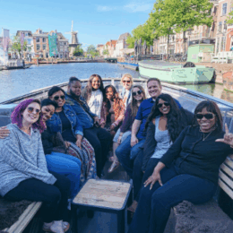 Counseling students sitting on a boat in a river