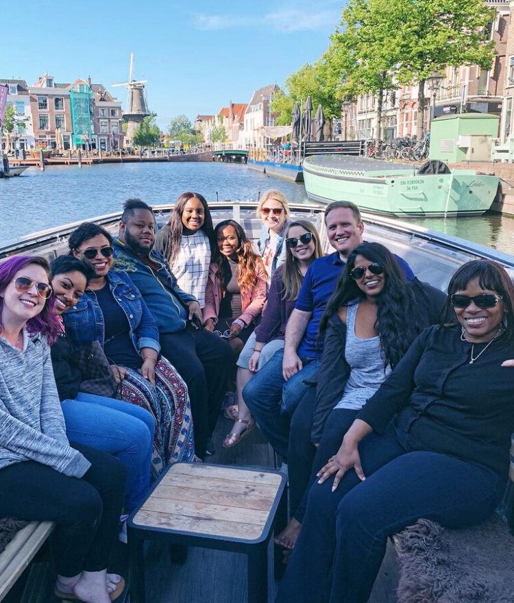Counseling students sitting on a boat in a river
