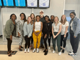 counseling students standing and smiling in the airport