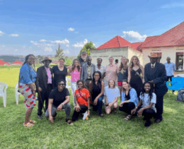 group of counseling students standing outside a house smiling